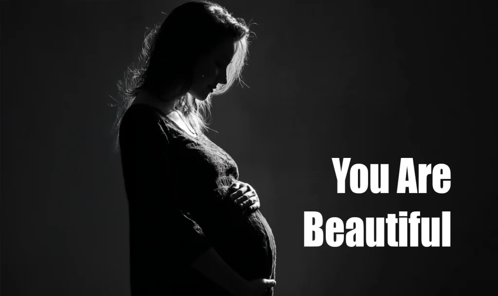 Minimal monochrome silhouette of a pregnant woman holding her belly with “You Are Beautiful” text overlay.