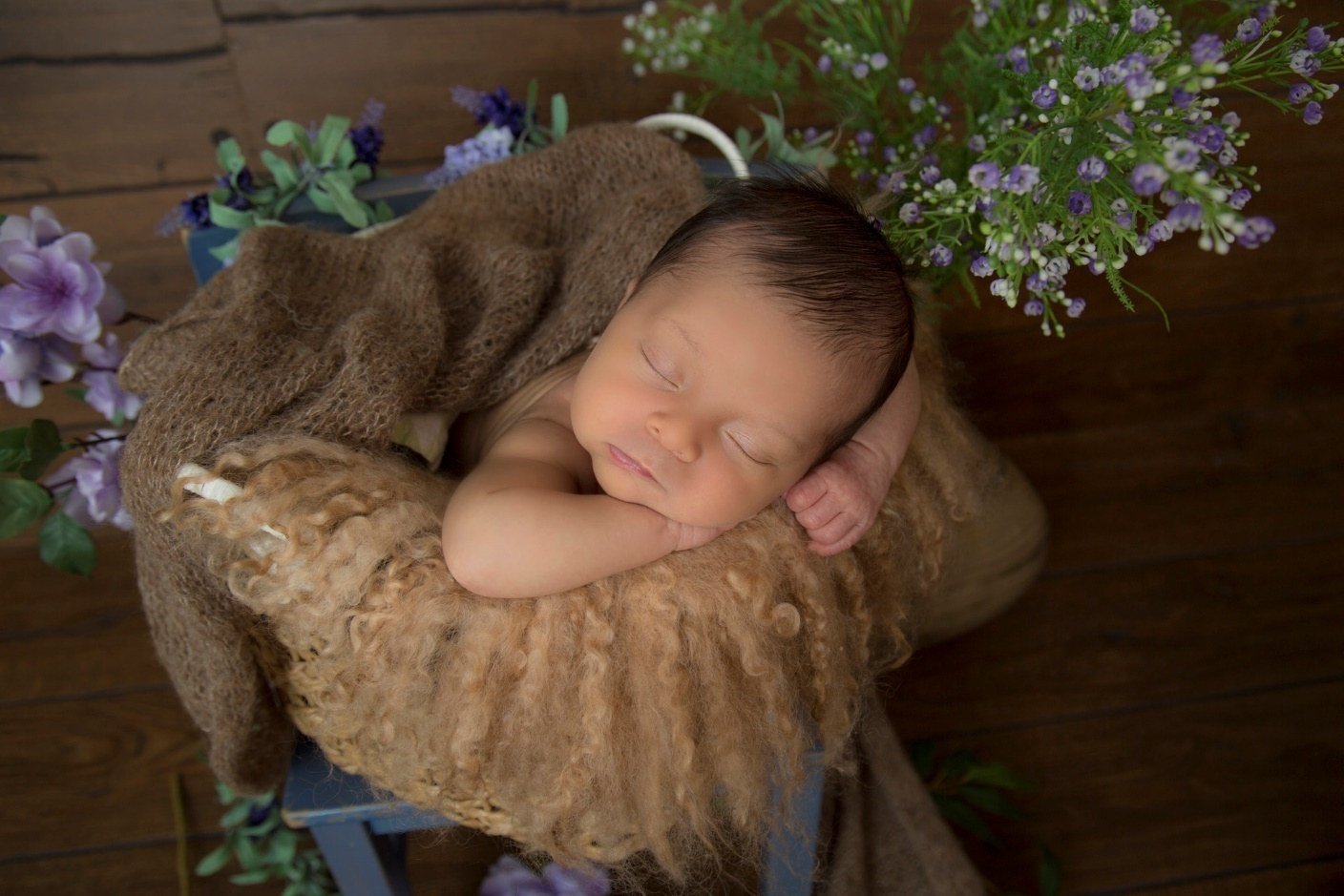 A picture of a sleeping baby inside a basket