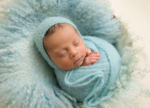 Newborn baby wrapped around a soft blanket