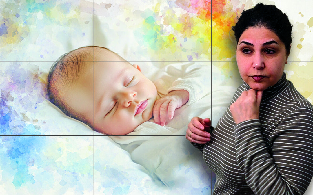 A photographer is trying to figure out the composition for a newborn photo