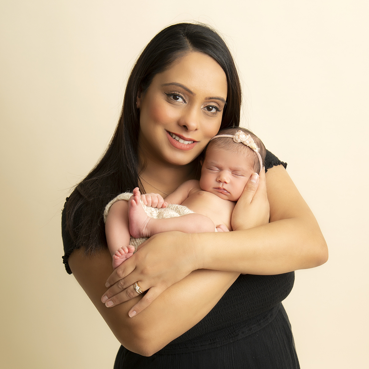 mom holding baby cradle pose newborn photography surrey client at artin photography studio